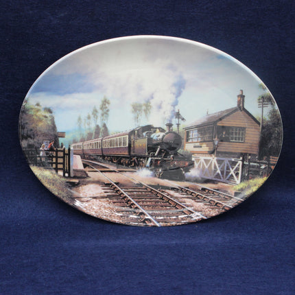 Decorative plate with a steam train design on a blue background