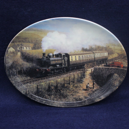 Decorative plate with a steam train scene on a blue background