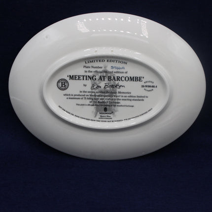 White ceramic plate with engraved text on a dark background