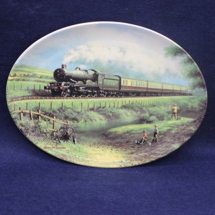 Decorative plate with a steam train and countryside scene on a blue background