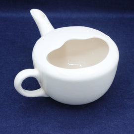 White ceramic jug with a spout on a blue background