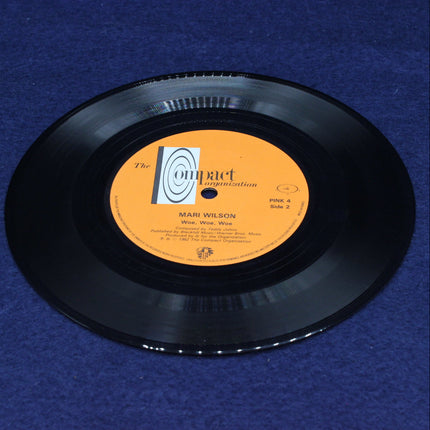 Woe, Woe, Woe Vinyl record with an orange label on a blue background