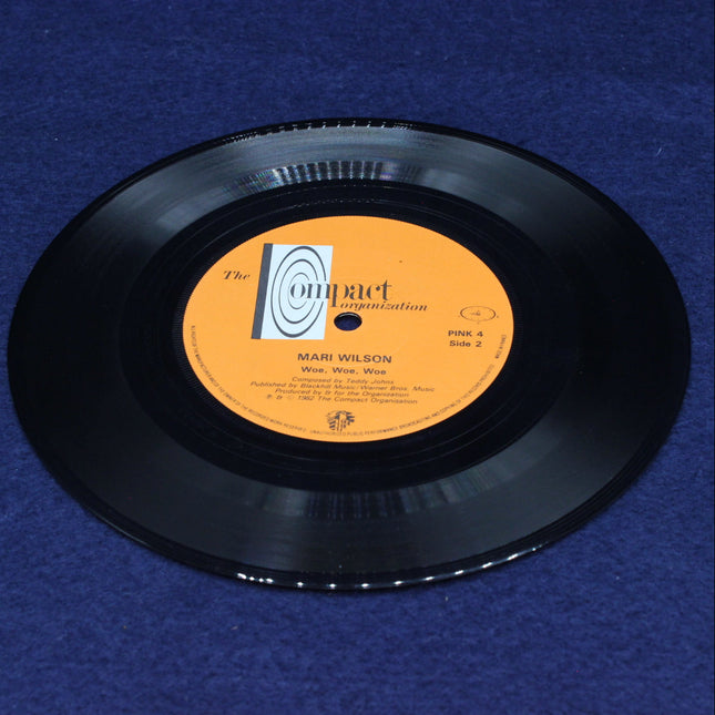 Woe, Woe, Woe Vinyl record with an orange label on a blue background