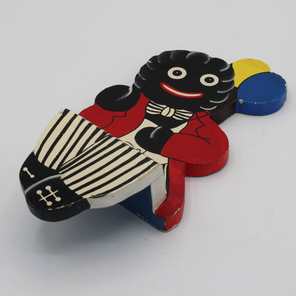 A vintage wooden Golly sitting shelf ornament.