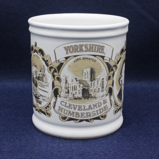 White mug with black and gold Yorkshire-themed design on a blue background