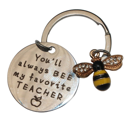 Keychain with engraved message and bee charm on a white background