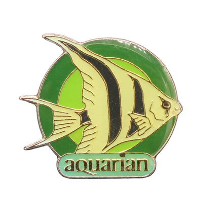 Pin with fish design and 'aquarian' text on a dark blue background