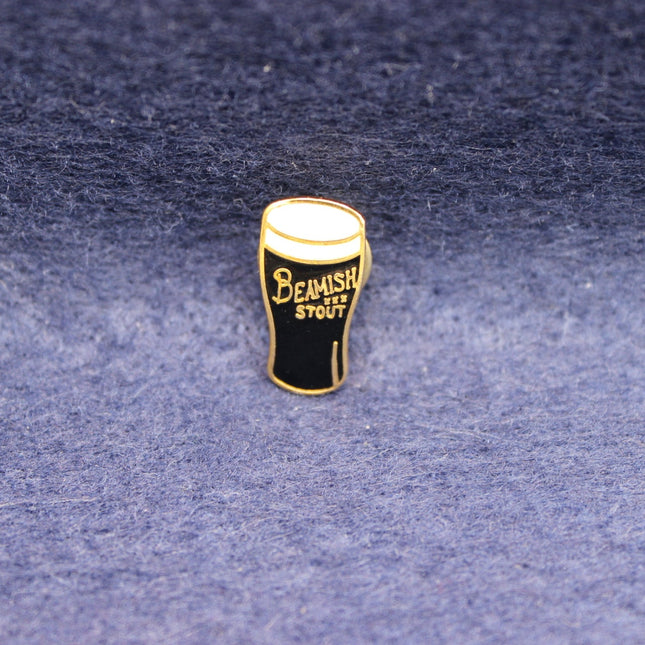 Vintage Beamish Irish Stout pint‑glass badge with classic black‑and‑gold branding.