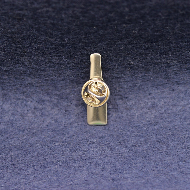 Rear of a Becks Bottle pin badge showing the butterfly clasp