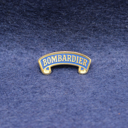 Vintage Bombardier Bitter enamel pin in blue and gold.