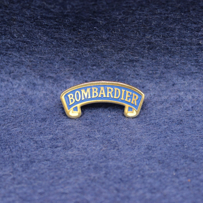 Vintage Bombardier Bitter enamel pin in blue and gold.
