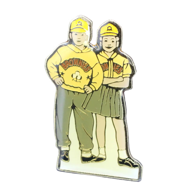 Pin with two characters in yellow hats and shirts on a blue textured background