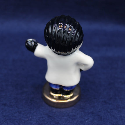 Small figurine of a Golly Doctor on a blue background