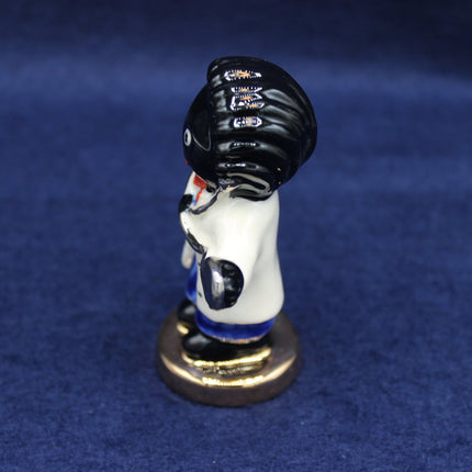 Golly Doctor Figurine on a blue background