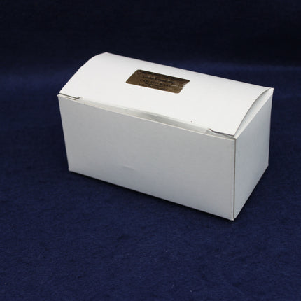 White box with a gold emblem on a dark blue background