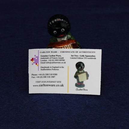Small Golly figurine with a certificate of authenticity on a dark background