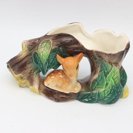 A ceramic woodland-themed planter shaped like a tree stump with a small fawn figurine, shown on a plain white background.