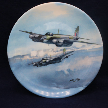Decorative plate with artwork of two airplanes flying in the sky.