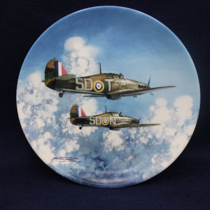 Decorative plate with artwork of two airplanes flying in the sky with clouds.