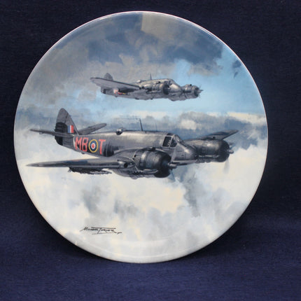 Decorative plate with artwork of two airplanes flying in the sky.