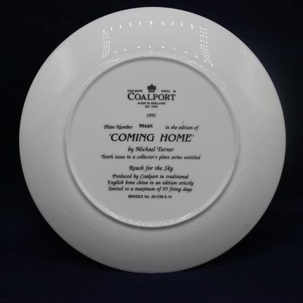 White plate with black text and Coalport branding on a dark background