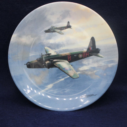 Decorative plate with an artistic depiction of a bomber aircraft flying in the sky.