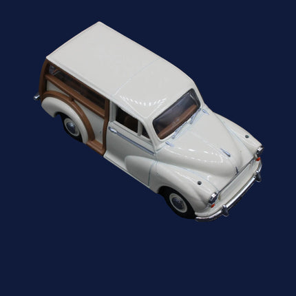 Model of a vintage car with a white body and brown roof on a dark background