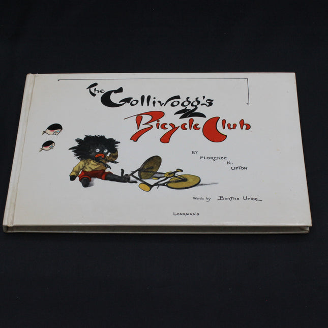 Book titled 'The Golliwog's Bicycle Club' with a cover illustration on a dark background
