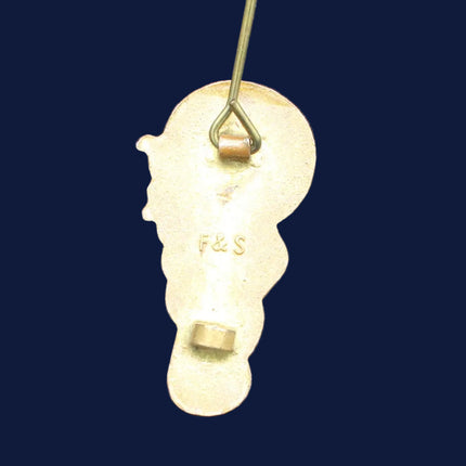 Rear of a Golly Bagpiper badge