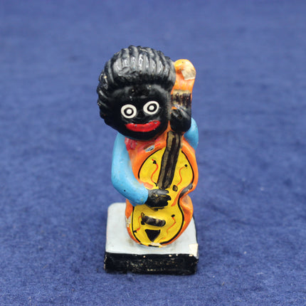 Figurine of a character with a large head, holding a guitar on a blue background