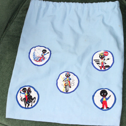 Light blue drawstring bag with embroidered Golly patches