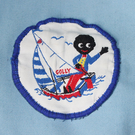 Embroidered patch of a character on a sailboat with 'Golly' text on a light blue background