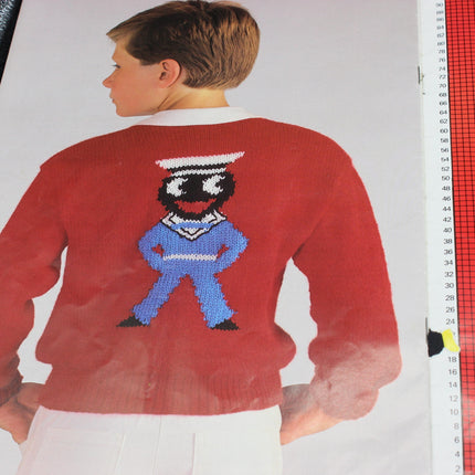 Red sweater with a golly sailor character on the back, worn by a person, against a white background.