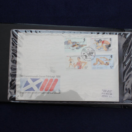 A collectible 1986 UK Commemorative Green Edging First Day Cover envelope, featuring swimmer stamps and a Scottish flag postmark, sealed inside a clear protective plastic sleeve.