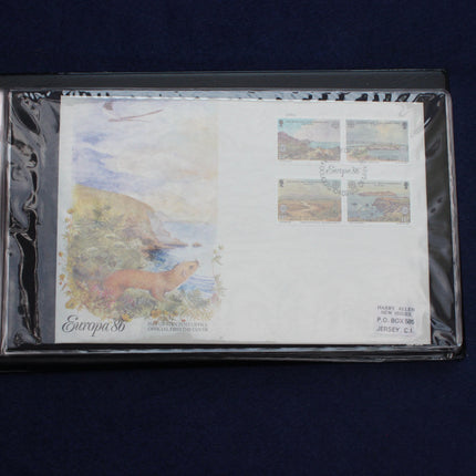 A collectible first-day postage envelope from Papua New Guinea, featuring a landscape illustration and a four-piece stamp block, sealed inside a protective plastic sleeve and displayed on a dark blue background.
