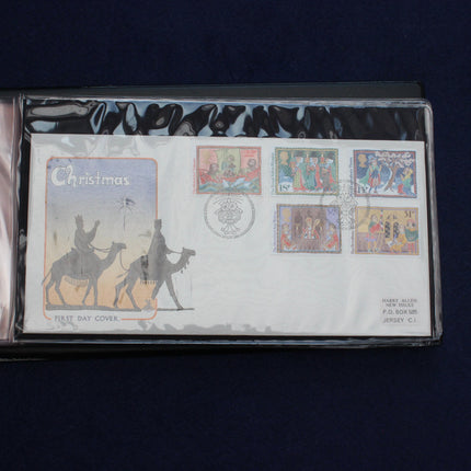A collectible Christmas-themed postage day cover from 2001, featuring six Christmas postage stamps and a postmark, housed in a clear protective plastic sleeve against a dark blue background.