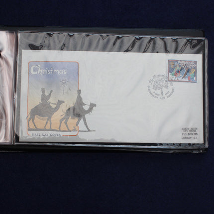 A collectible first-day cover envelope from 1981 featuring a Christmas theme, displayed inside a protective plastic sleeve on a dark blue background.