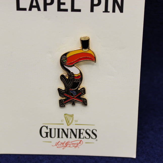 Guinness lapel pin on a card with a dark background