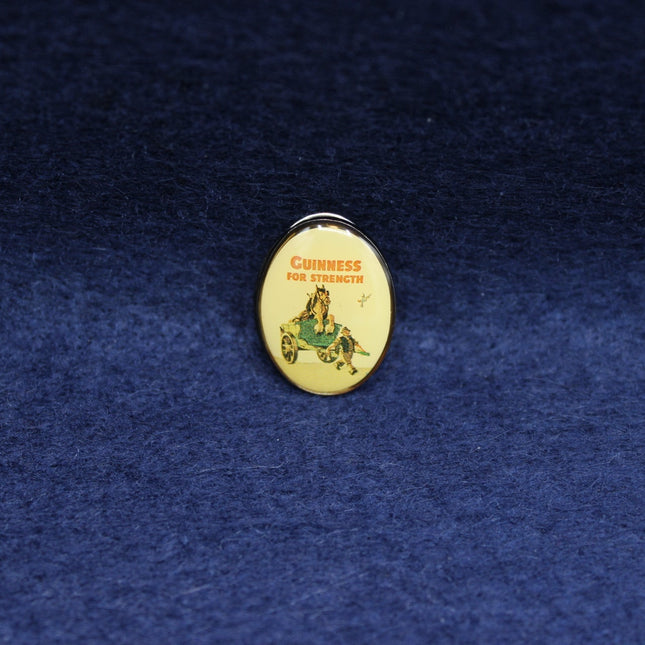 Pin Badge with Guinness logo on a blue textured background