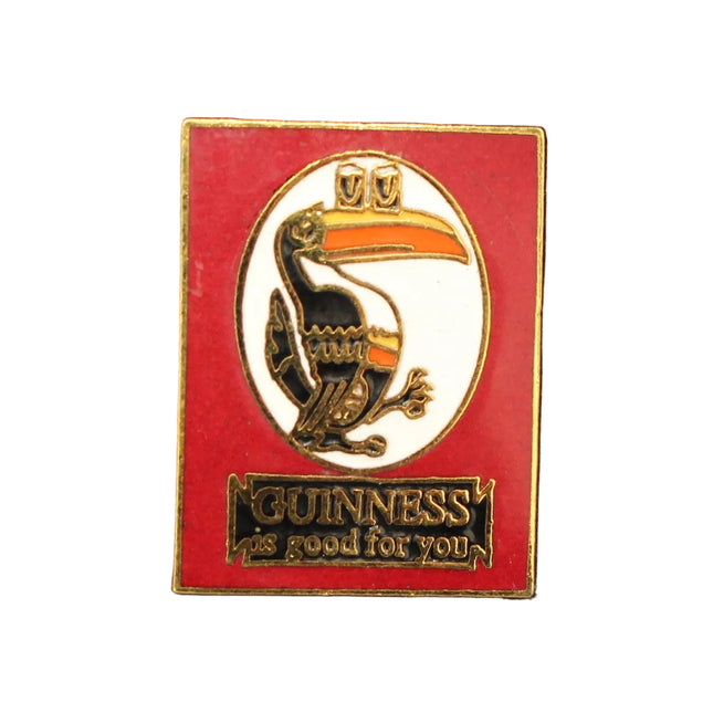Red and gold Guinness badge on a dark blue fabric background