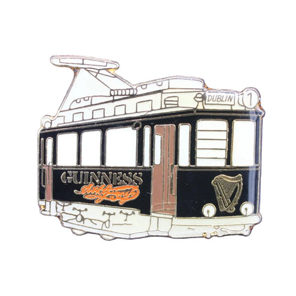 Pin with a design of a tram and Guinness logo on a blue background