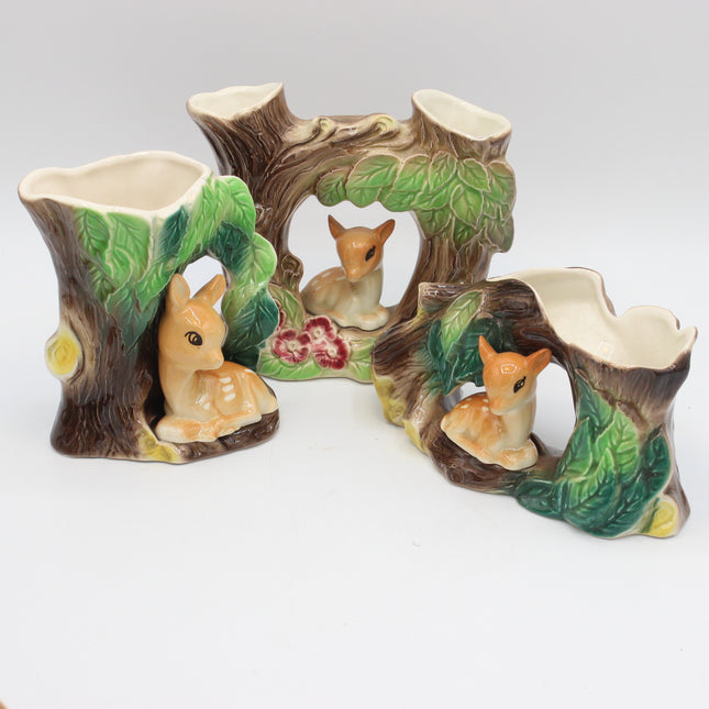 3 hornsea pottery vases with fawns on them shaped lone tree trunks on a white backround