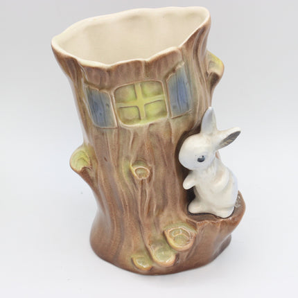 A ceramic tree stump hornsea pottery ceramic planter with a small white rabbit figurine on the side, featuring a glazed brown bark texture, faux window details, and a cream-colored interior.