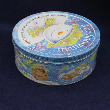 Round tin container with colorful design on a dark background