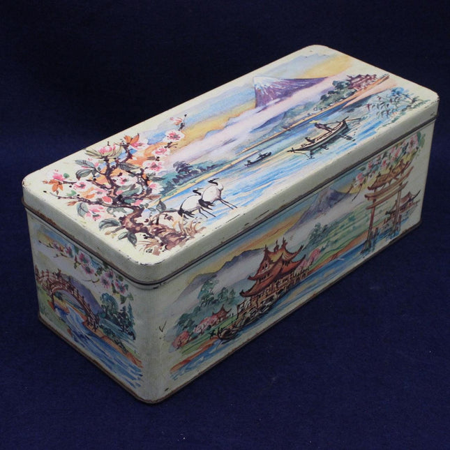 Decorative vintage tin box with lake design on a blue background