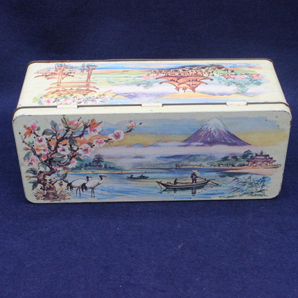 Decorative tin box with a scenic design on a blue background