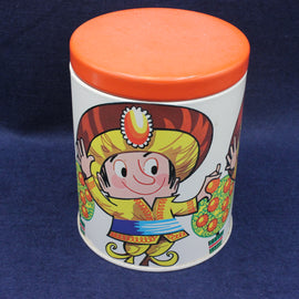 Decorative container with a colorful illustration of a Jaffa Cake character on an orange lid against a dark background
