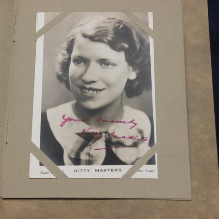 Vintage photo of kitty masters with a signature on a brown background