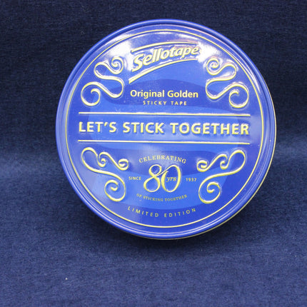 Blue container of Sellotape with gold text on a dark blue background