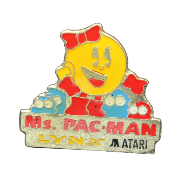Pin featuring Ms. Pac-Man character from Atari on a blue textured background